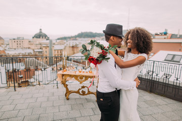 African wedding couple dances on the rooftop. Wedding day