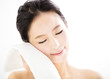 © Tom Wang - young woman cleaning her face with  towel