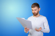 © fotofabrika - Portrait of smart businessman looking through papers