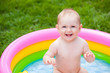 Portrait of a baby in a swimming pool in the summer