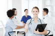 © Syda Productions - happy doctor over group of medics at hospital