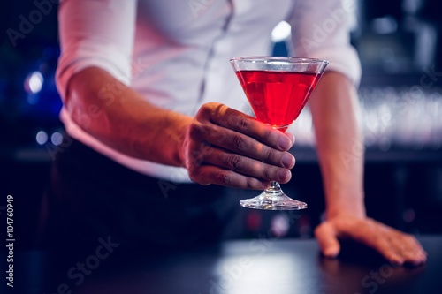 Bartender serving a red martini Wallpaper Mural