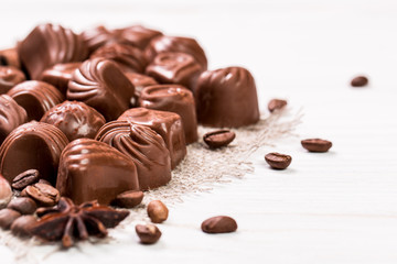 Delicious chocolate candies on wooden background