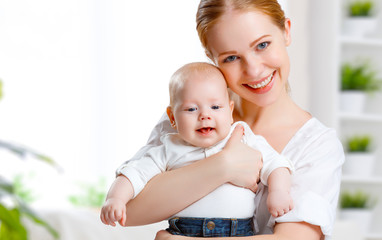 Wall Mural - happy family mother hugging her baby