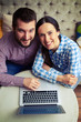 cheerful couple with laptop
