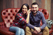 © ArtFamily - portrait of young couple sitting on sofa