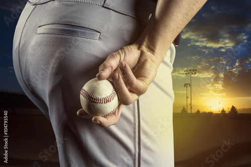 Fotografie, Obraz Baseball pitcher ready to pitch in an evening baseball game