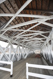 Fototapeta Most - Interior of historic, white covered bridge, Groveton, New Hampsh