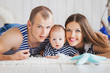 Happy young family in the studio on a bright white background wi