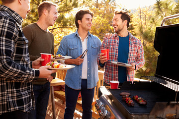 Wall Mural - Group Of Gay Male Friends Enjoying Barbeque Together