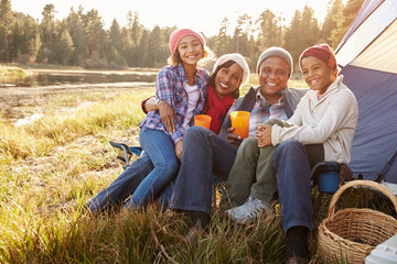 Portrait Of Grandparents With Children Camping By Lake