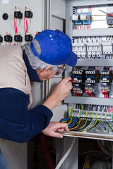 Wall Mural - electrician at work with an electric panel