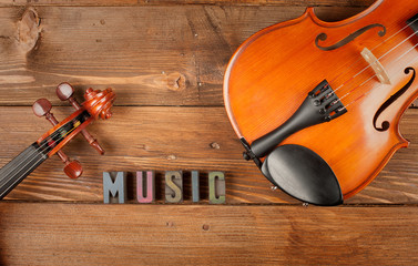 Wall Mural - violins in wood background and word music in letterpress type