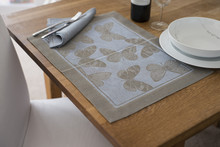 Placemat With Butterfly Design On Table With Bowl And Utensils