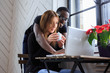 © Fxquadro - Blackman and young woman working with laptop.
