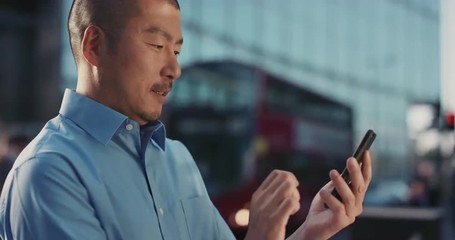 Slow Motion Portrait of Japanese businessman using smart phone