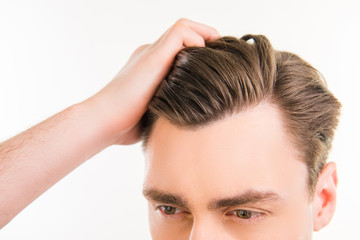 Close up photo of healthy man combing his hair with fingers