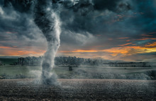 Black Tornado Funnel Over Field During Thunderstorm. Apocalypse Scenario.