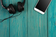 phablet and headphones on the wooden desk