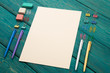 Blank sheet of paper and colorful office accessories