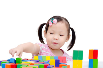 Wall Mural - Little girl playing colorful wood blocks