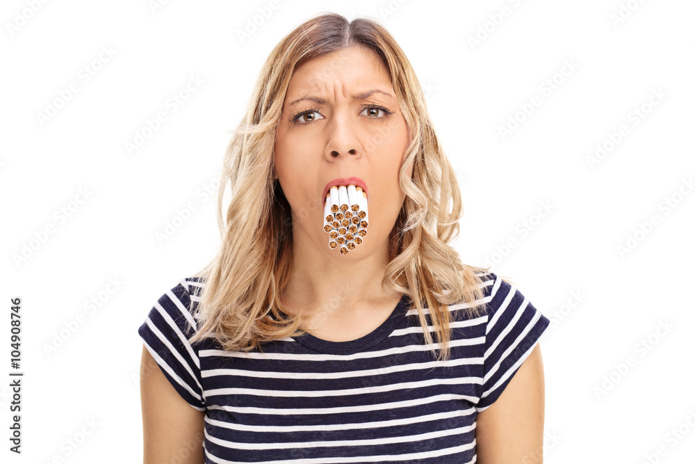 Woman with a bunch of cigarettes in her mouth Stock Photo