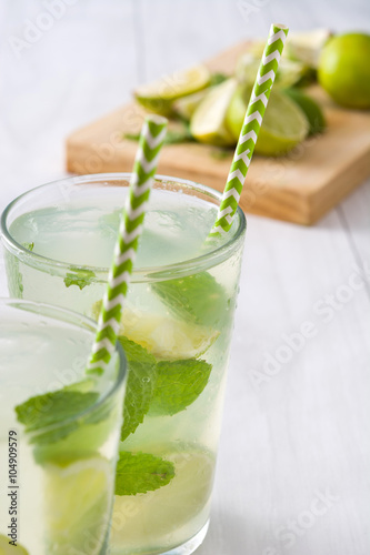 Plakat Summer drink. Fresh mojito with lime and mint. Blue background