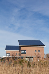 Wall Mural - Family house with solar panels for alternative energy