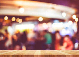 Poster - Empty wood table and blurred cafe light background. Business pre