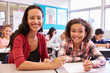 © Monkey Business - Portrait of teacher with elementary school girl at her desk