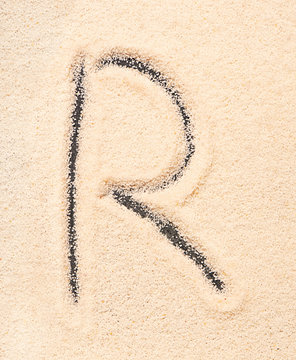 R letter written on sand
