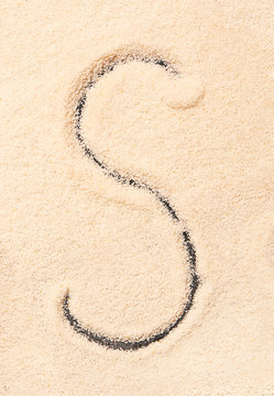 S letter written on sand