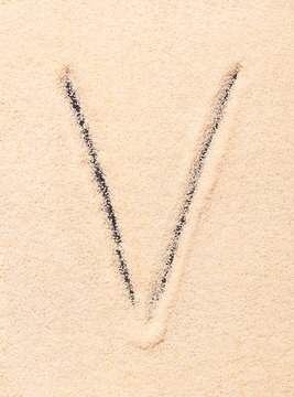V letter written on sand