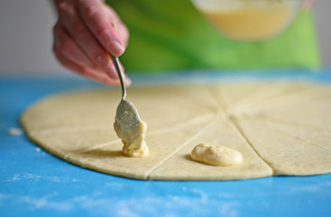 Woman preparing rolls with cheese and ham - close up of souce fo