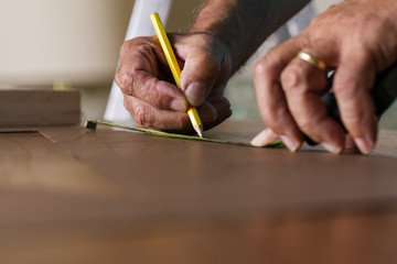 Carpenter measuring with meter