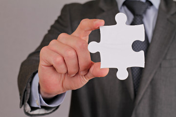 Business solution concept. Business man holding piece of puzzle. Copy space image