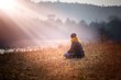 © milosz_g - Young woman sitting on grass on meadow