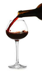 Canvas Print - Red wine pouring in glass, isolated on white