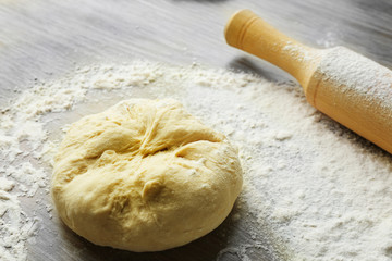 Canvas Print - Fresh prepared dough on a wooden board, close up