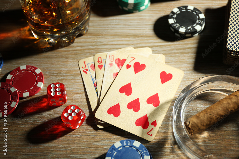 Set to playing poker with cards and chips on wooden background