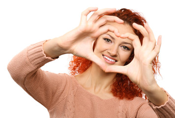 Poster - Red-haired young woman making heart with hands, isolated on white