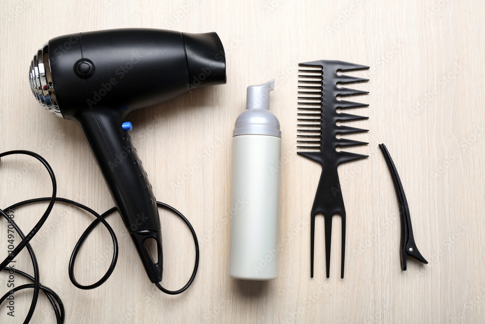 Barber set with tools, equipment and cosmetic on light wooden table