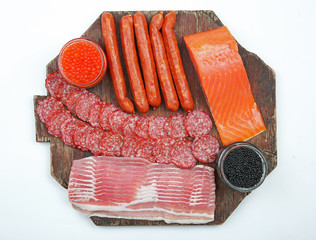 Poster - A set of smoked sausages, bacon and salmon  isolated on white