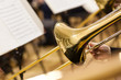 Detail of a trombone in the hands of the musician closeup