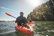 © Jacob Lund - Couple kayaking in the lake on a sunny day