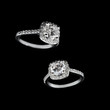 Luxury jewellery. White gold or silver engagement rings with diamonds closeup on black background. Selective focus.