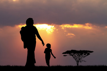 Wall Mural - African woman and child at sunset