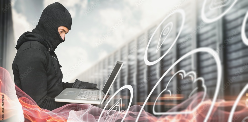 Side view of hacker using laptop against blue glowing black background