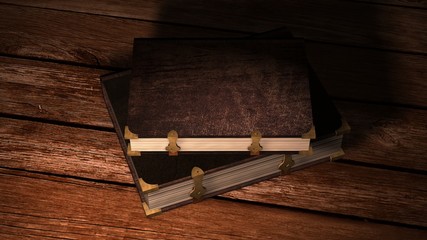 two old leather books with metal claps on wooden table 