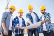 © Syda Productions - group of builders with tablet pc and blueprint